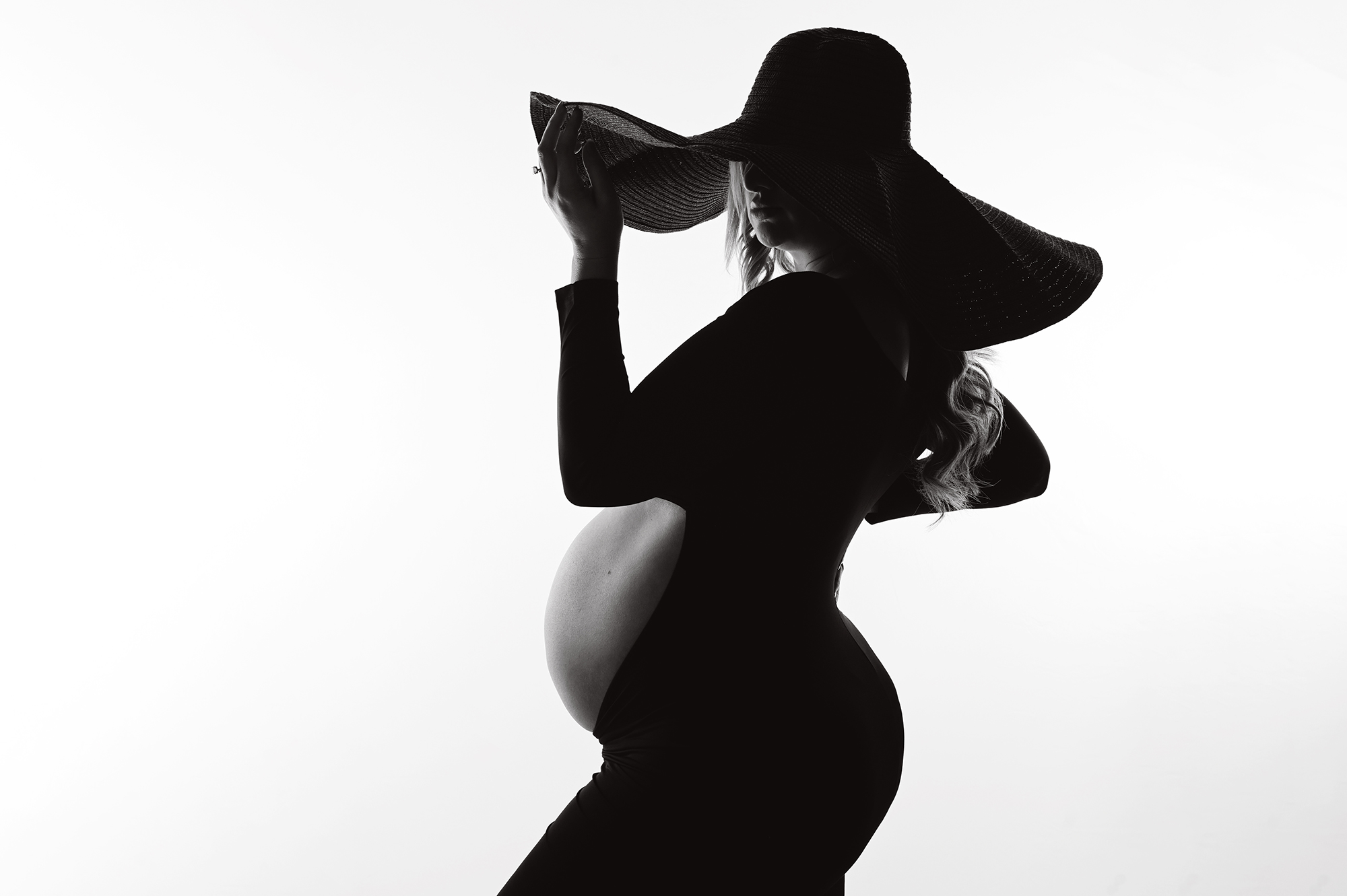 newborn session with Cherilyn Haines photography; newborn baby girl is photographed wearing a dainty lace and sequin bonnet