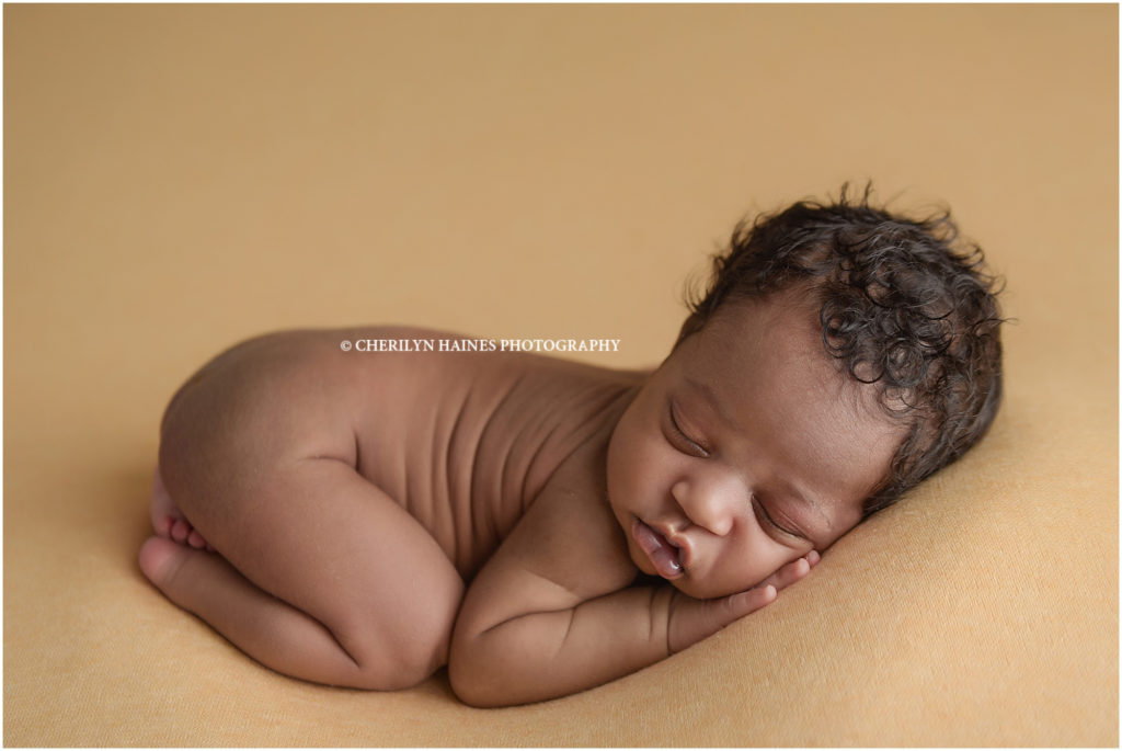 newborn photography session in Batno Rouge, Louisiana with Cherilyn Haines Photography; 14 day old newborn baby boy photographed laying on yellow blanket