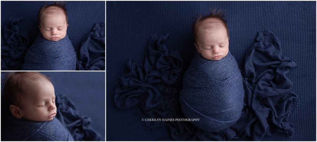 newborn baby boy swaddled in navy blue and sleeping for session