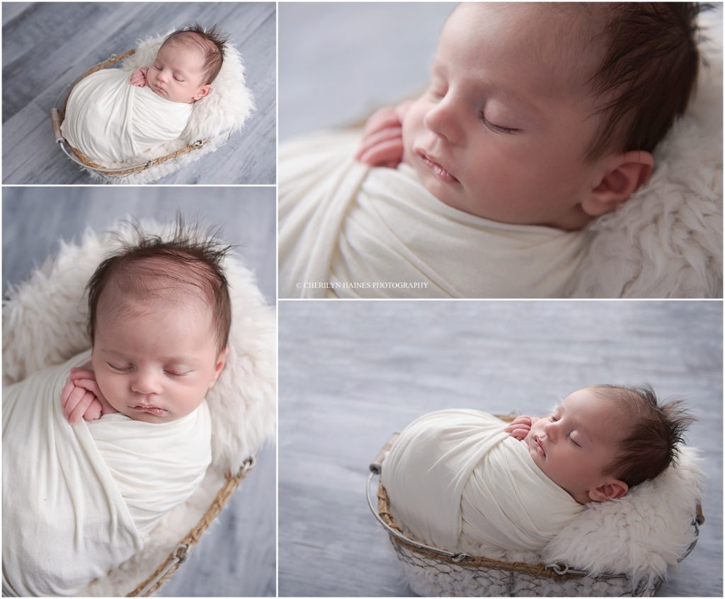 6 week old newborn baby boy photographed swaddled in white laying in metal basket