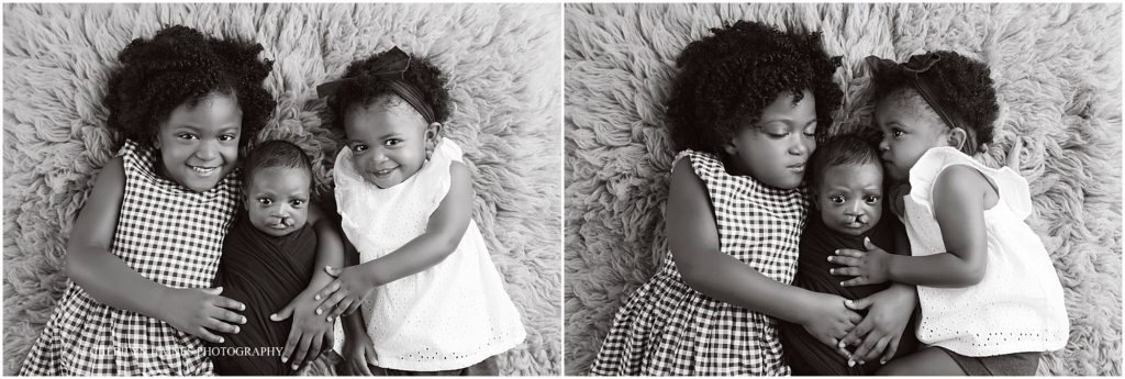 black and white portraits of newborn baby boy being held by his two big sisters; photographed by cherilyn haines photography