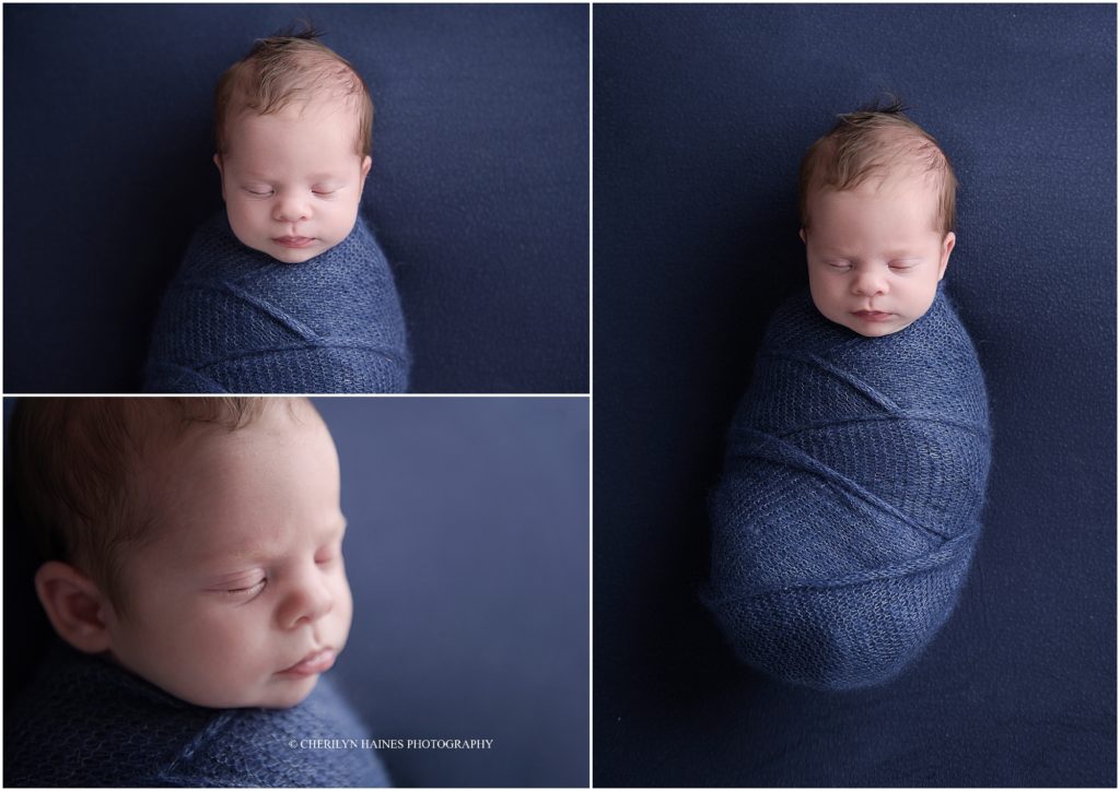 3 week old newborn boy swaddled in navy laying on navy blanket