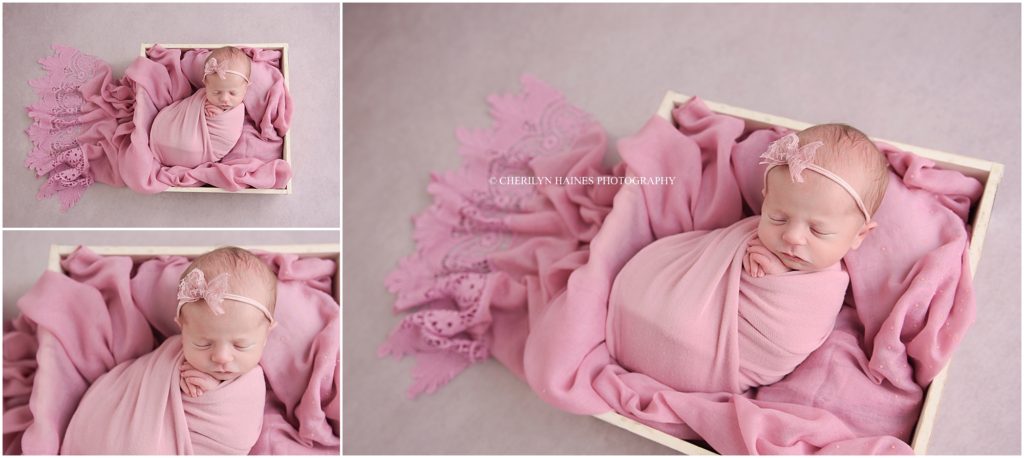 newborn baby girl photographed swaddled in pink