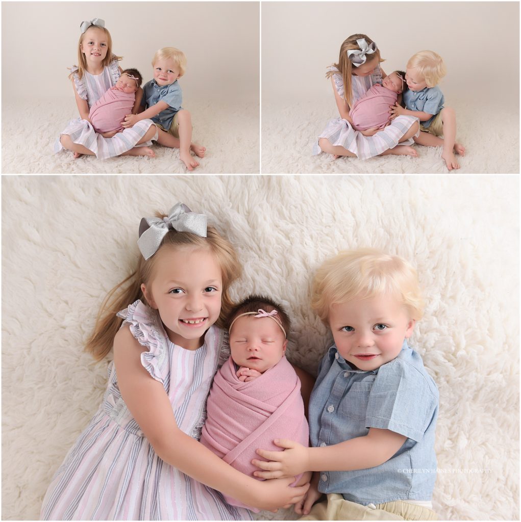 newborn baby girl photographed with brother and sister