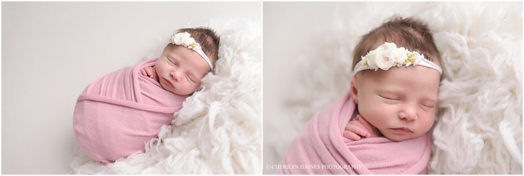 10 day old newborn baby girl photographed swaddled in pink