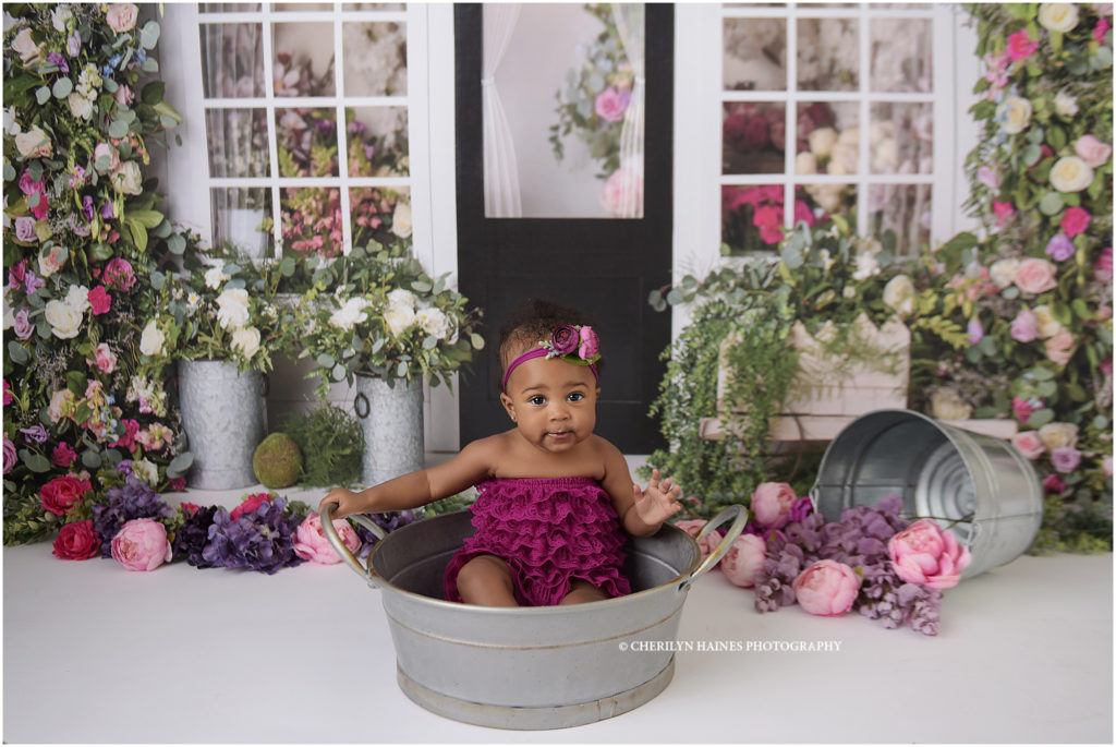 6 month old baby girl photographed in front of flower shop setup; photographed by cherilyn haines photography in denham springs, louisiana