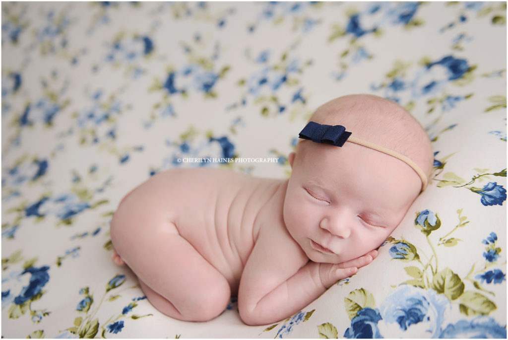 2 week old newborn baby girl photographed sleeping on blue floral fabric; photographed by cherilyn haines photography in baton rouge, louisiana