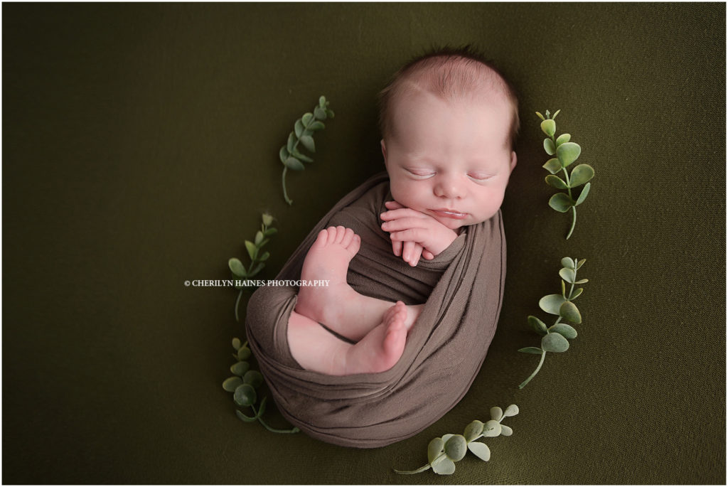 2 week old newborn baby boy photographed on olive green blanket by cherilyn haines photography in baton rouge, louisiana