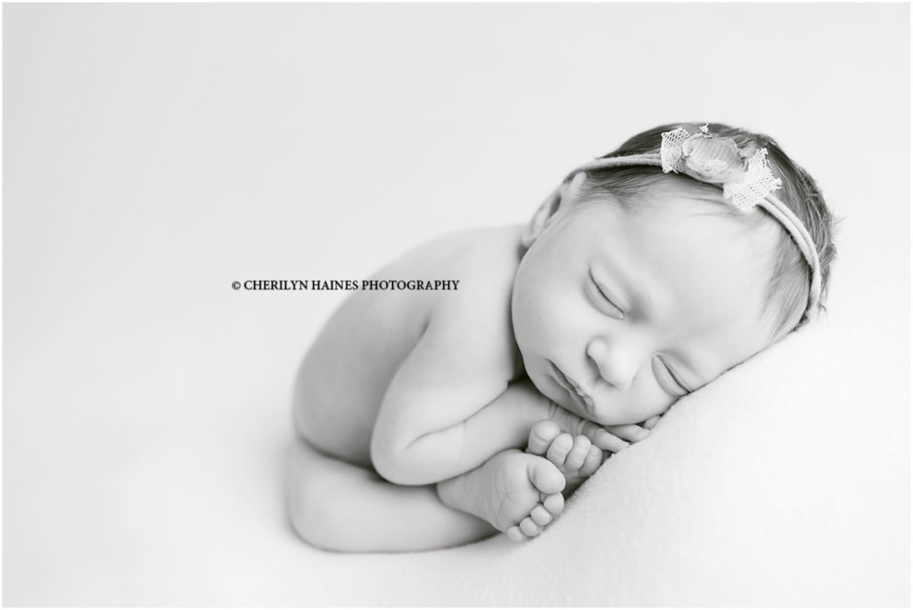 black and white fine art newborn portrait of 1 week old newborn baby girl in womb pose; cherilyn haines photography in new orleans, louisiana