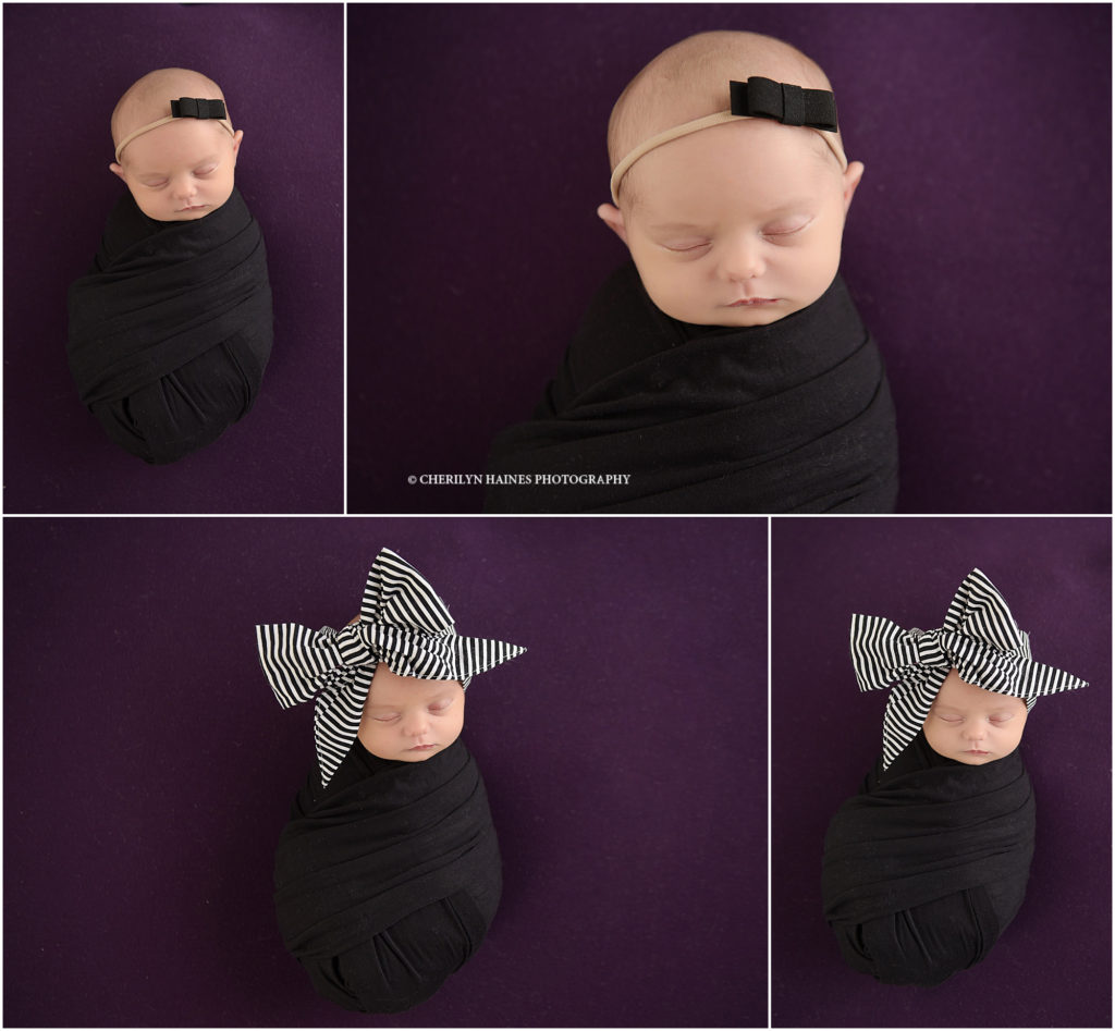 newborn baby girl photographed on purple blanket wearing large black and white striped headband