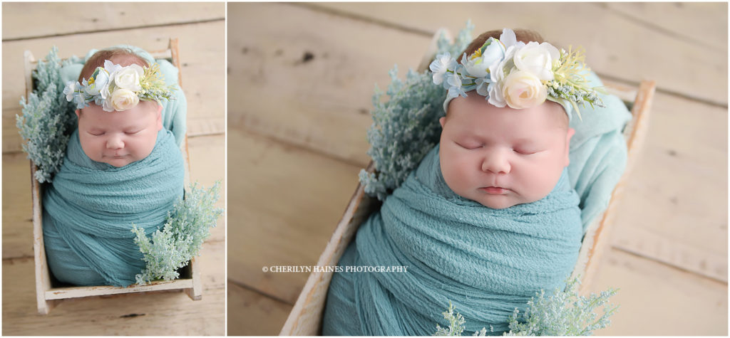 light blue themed newborn baby girl portraits; smiling baby