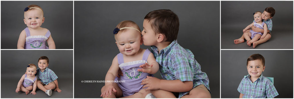 1 year old baby girl photographed with big brother on gray backdrop