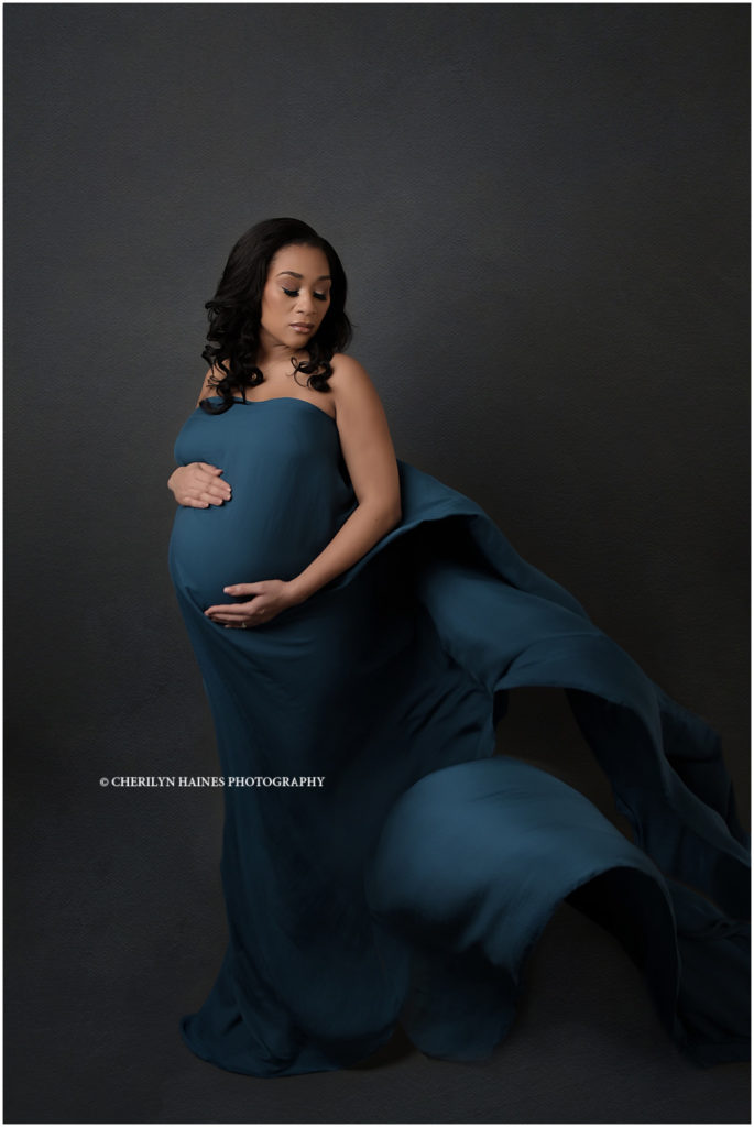 fine art maternity portrait session in Baton Rouge, Louisiana with Cherilyn Haines Photography; beautiful mama-to-be posing with long flowing dark teal silk chiffon fabric; maternity session in New Orleans, Louisiana