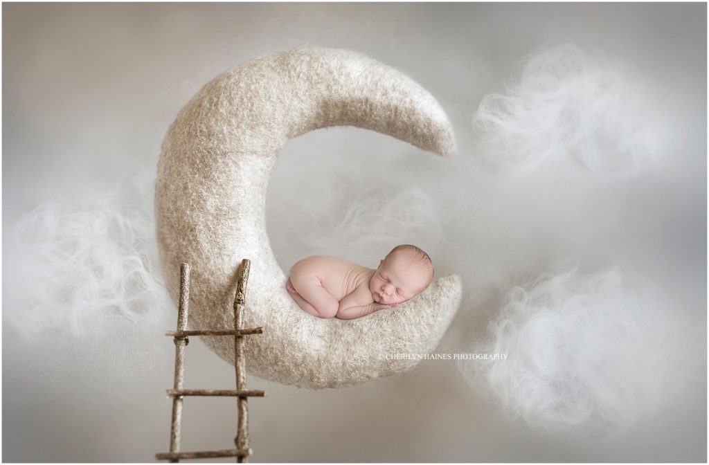 moon-themed newborn portrait session; newborn baby laying on moon; photographed by cherilyn haines photography