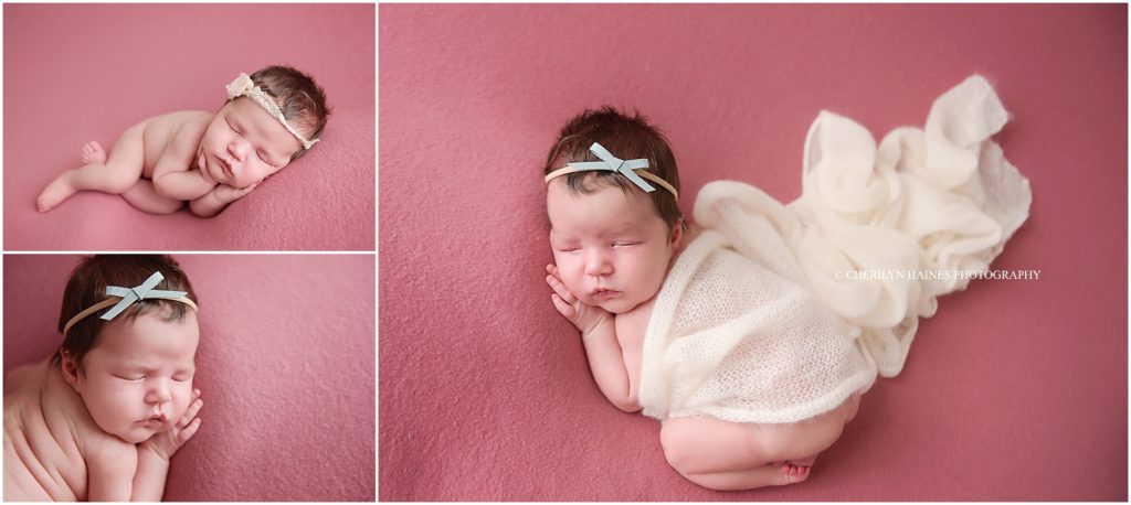 newborn posing on rose colored blanket