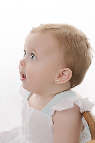 Smiling baby sitting during milestone photography session in Baton Rouge