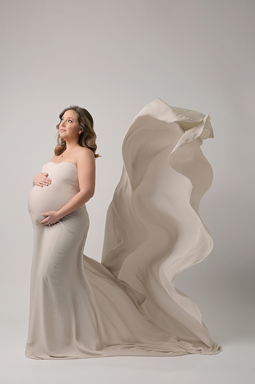 Maternity portrait with flowing silk fabric photographed in a Baton Rouge studio