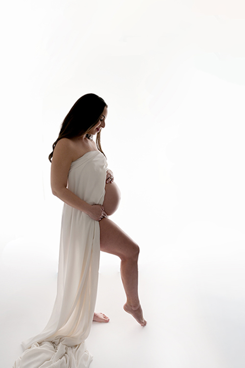 Artistic maternity portrait with dramatic lighting in Baton Rouge photography studio