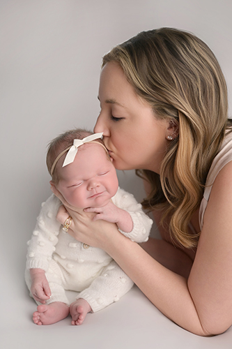 Parents holding their newborn baby during Baton Rouge studio session