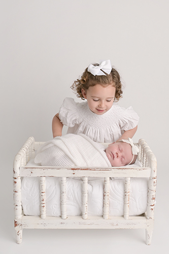 Timeless newborn baby and sibling portrait photographed in Baton Rouge studio