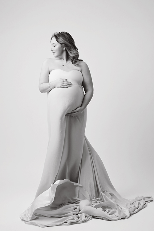 Pregnant mother wearing an elegant gown during a studio maternity photography session in Baton Rouge