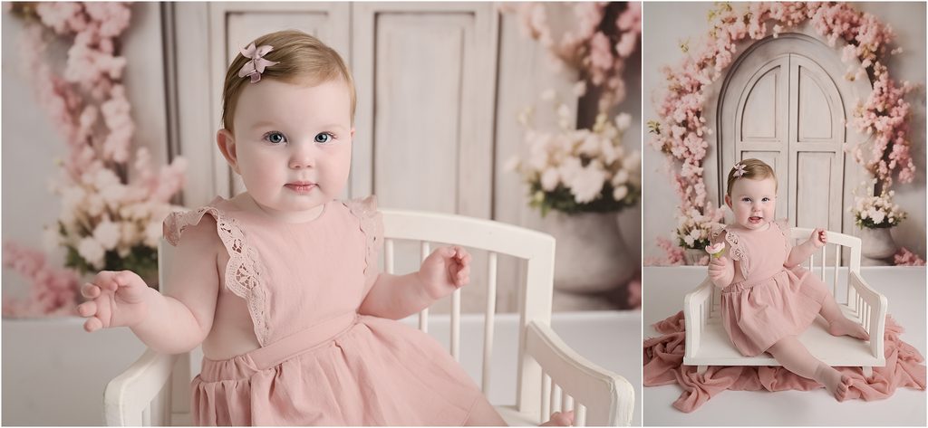 6 month old baby girl photographed with a pink floral archway backdrop
