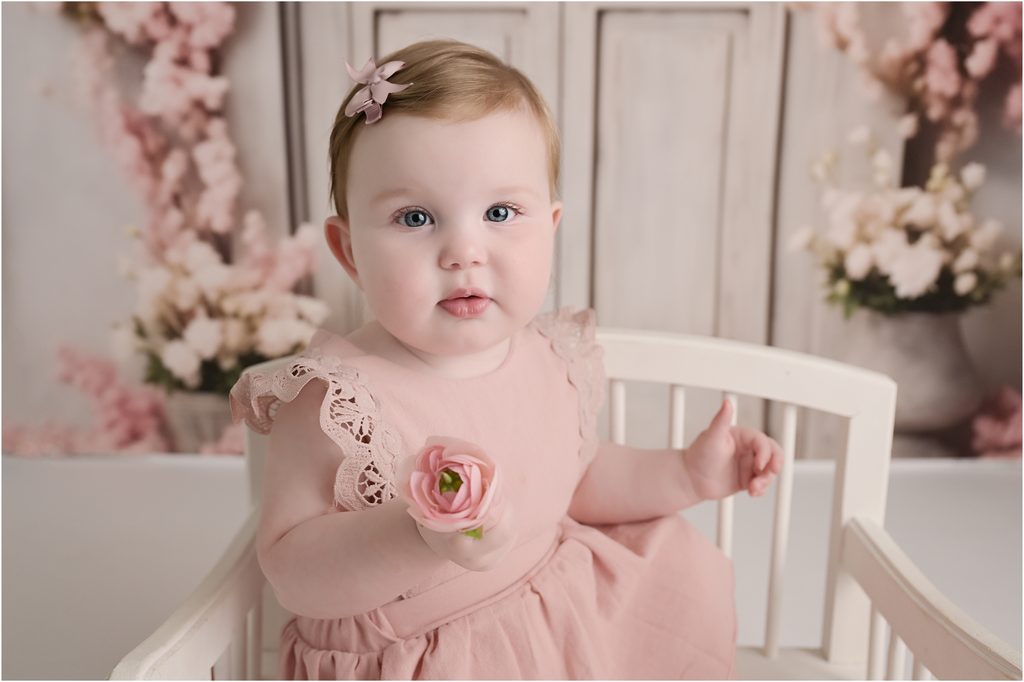 Feminine pink floral themed setup for baby photography at a Baton Rouge studio