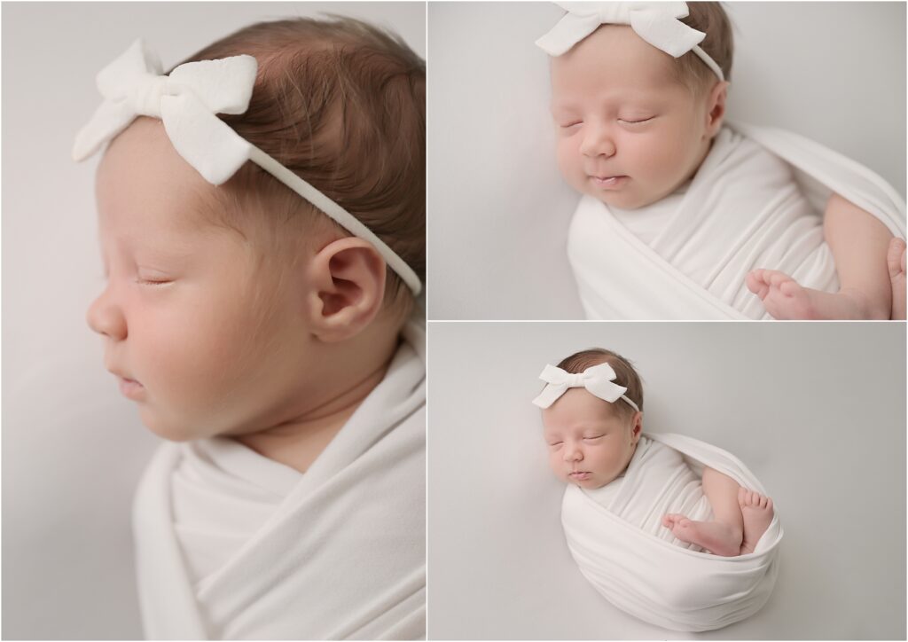 24-day-old newborn baby girl peacefully swaddled in a white wrap with a white bow