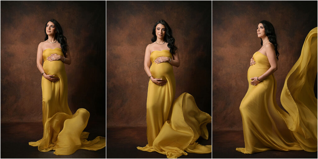 Pregnant woman posing in a flowing mustard yellow silk fabric during a Baton Rouge maternity photography session