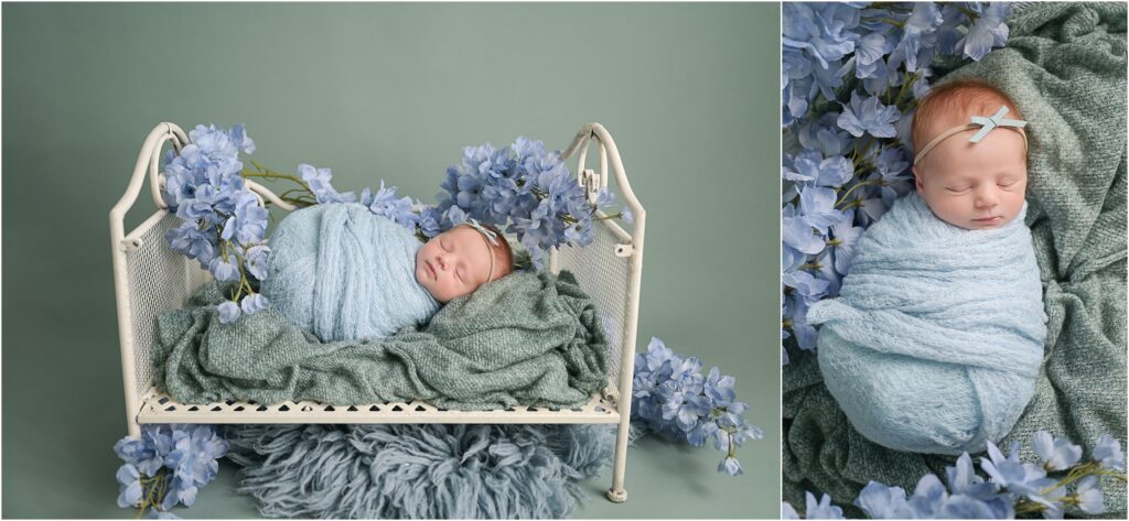 Newborn baby girl posed on an aqua backdrop in a light blue swaddle surrounded by light blue flowers