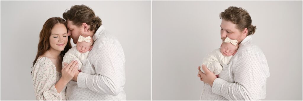 Father holding his newborn baby girl during a studio newborn session