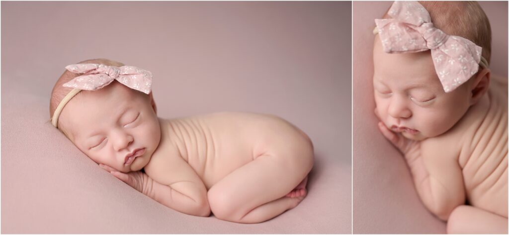 Newborn baby girl posed wearing a pink bow