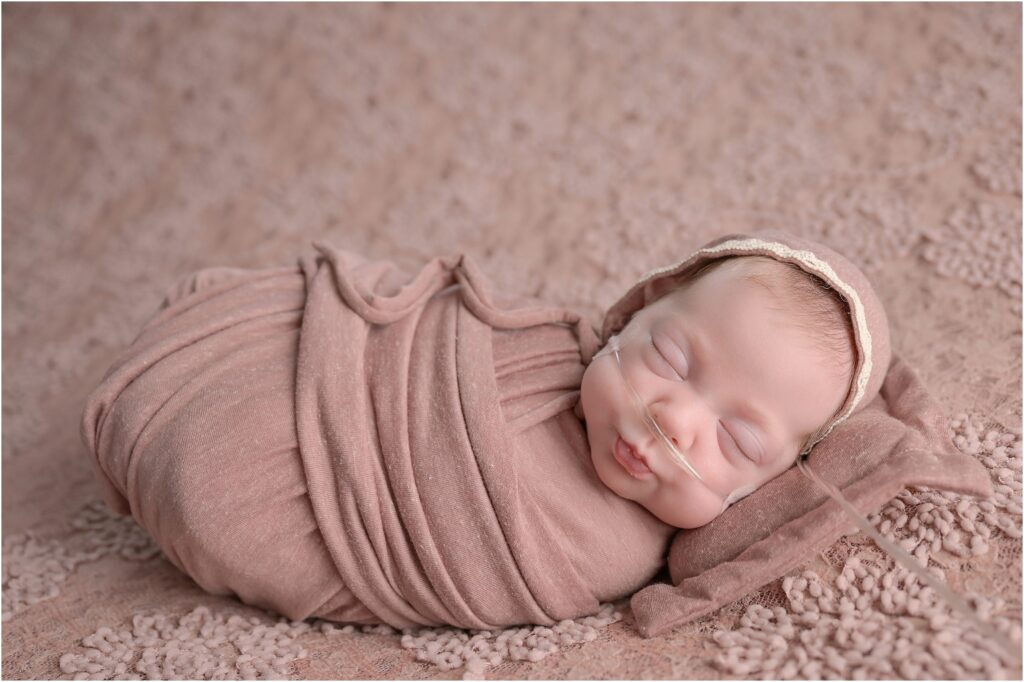 Baby girl Presleigh swaddled in an antique pink wrap and matching blanket by Cherilyn Haines Photography in Baton Rouge, Louisiana