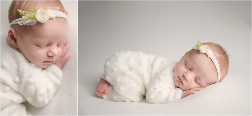 Newborn baby girl peacefully posed on her tummy wearing a white romper